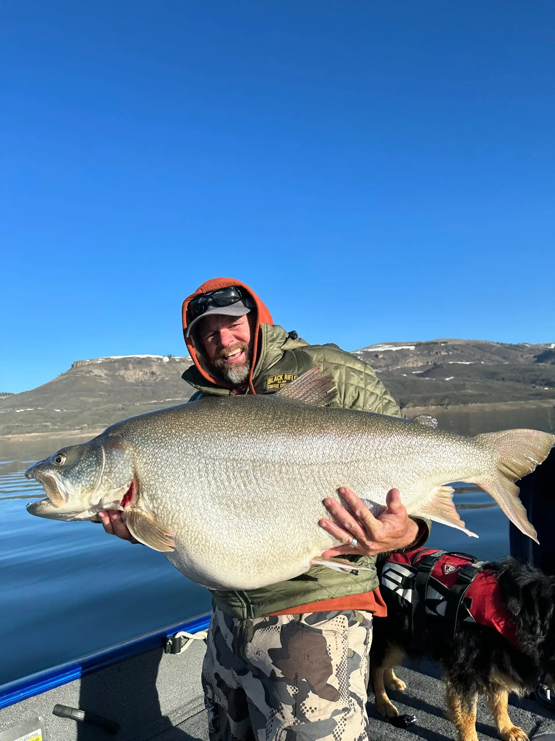 man holds giant lake trout