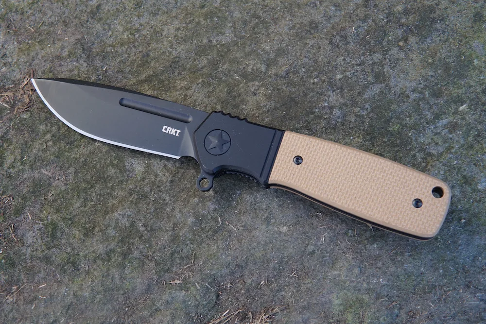 CRKT Homefront Compact Liner Lock Folding Knife sitting on rock