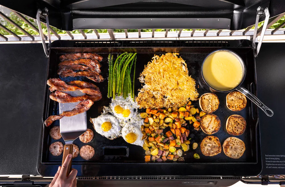 Assorted meats and vegetables cooking on Traeger Flatrock Griddle