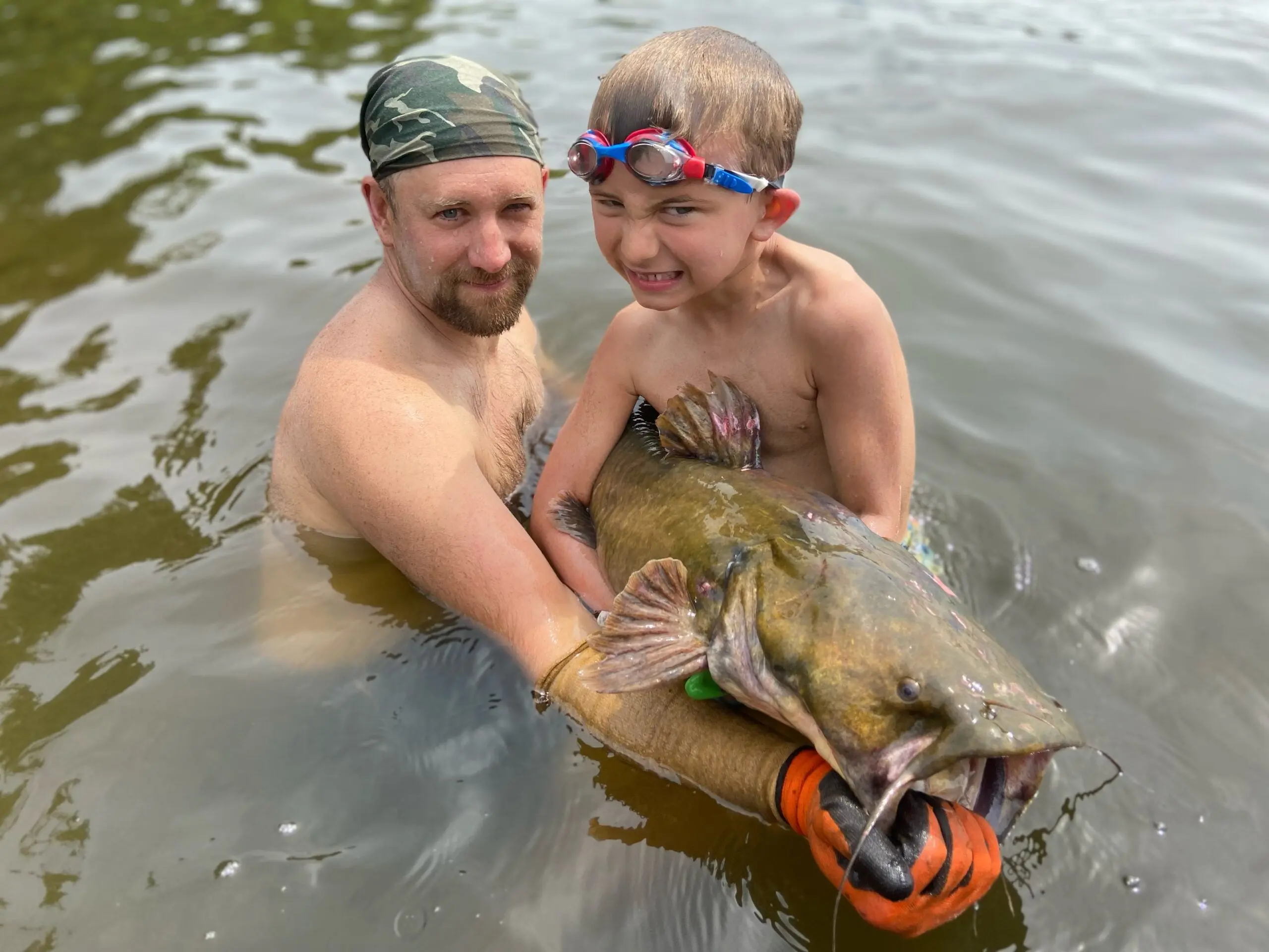 Photo of the article author and his son noodling for catfish. 