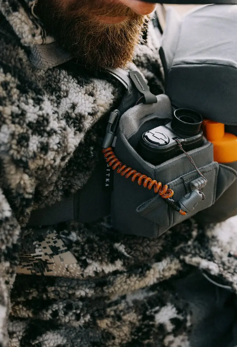 Hunter stores a rangefinder inside a Sitka bino harness. 