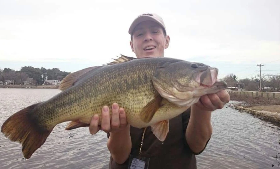 An angler poses with the Delaware record for largemouth bass. 