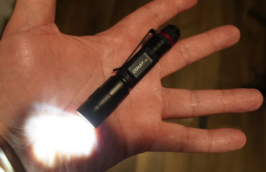 Close-up of man's hand holding Coast G22 flashlight