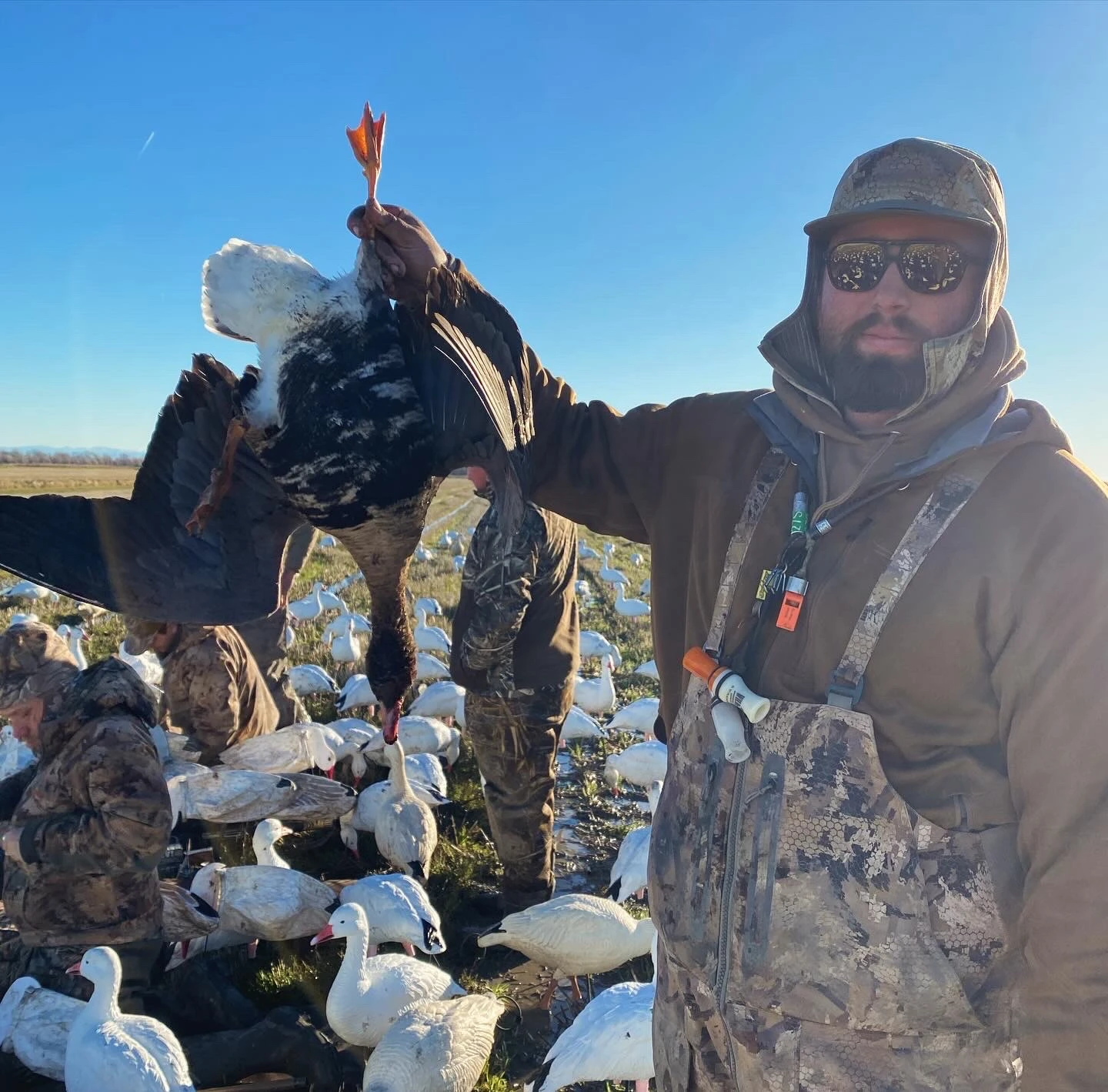 Hunter holding up a goose