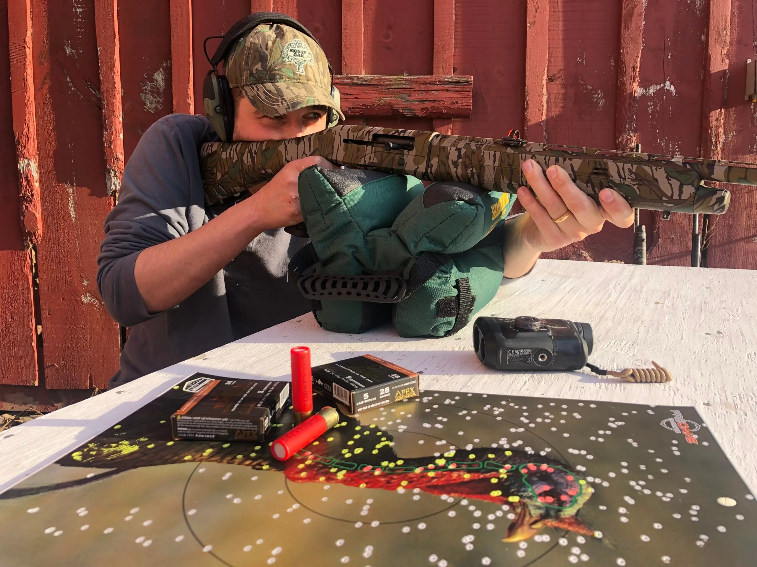 Man shooting a turkey shotgun in a 28 gauge vs 410 test.