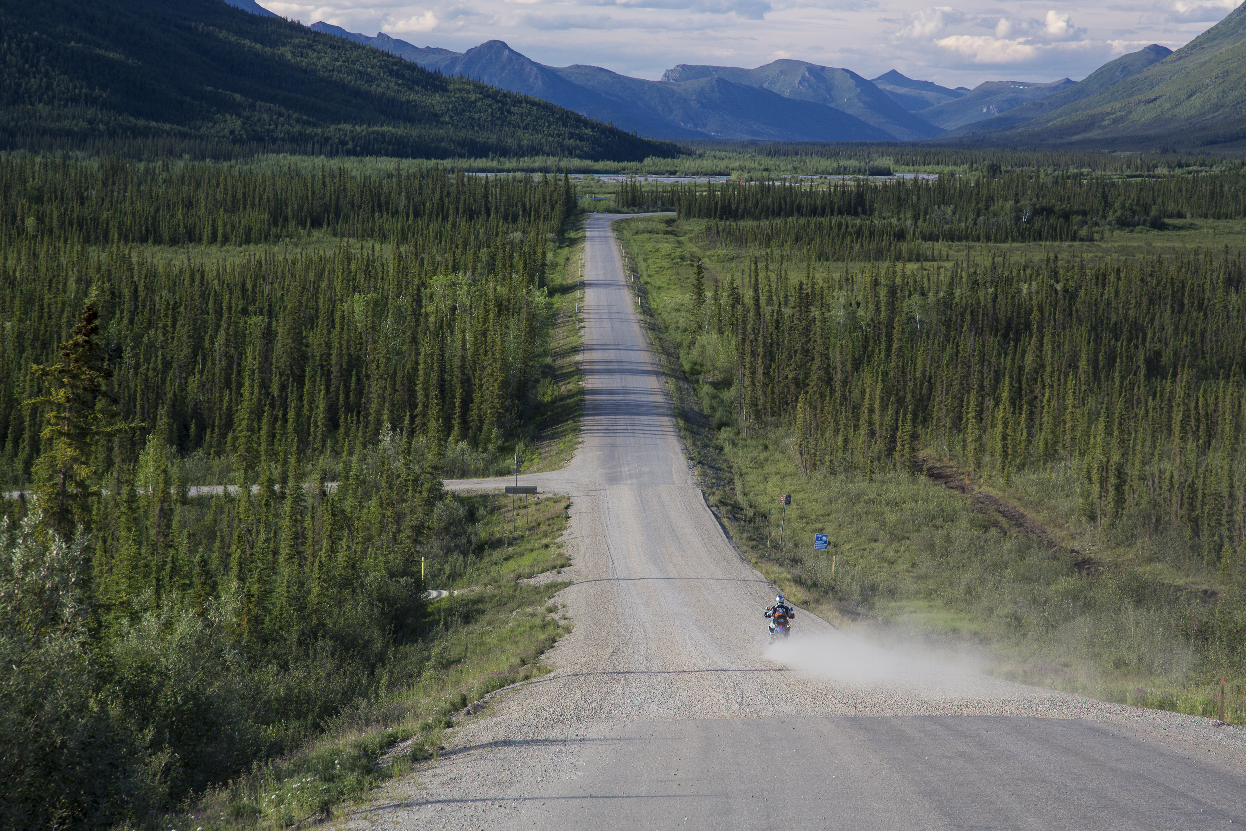 A motorcyclist traverses Alaska Dalton Highway. 