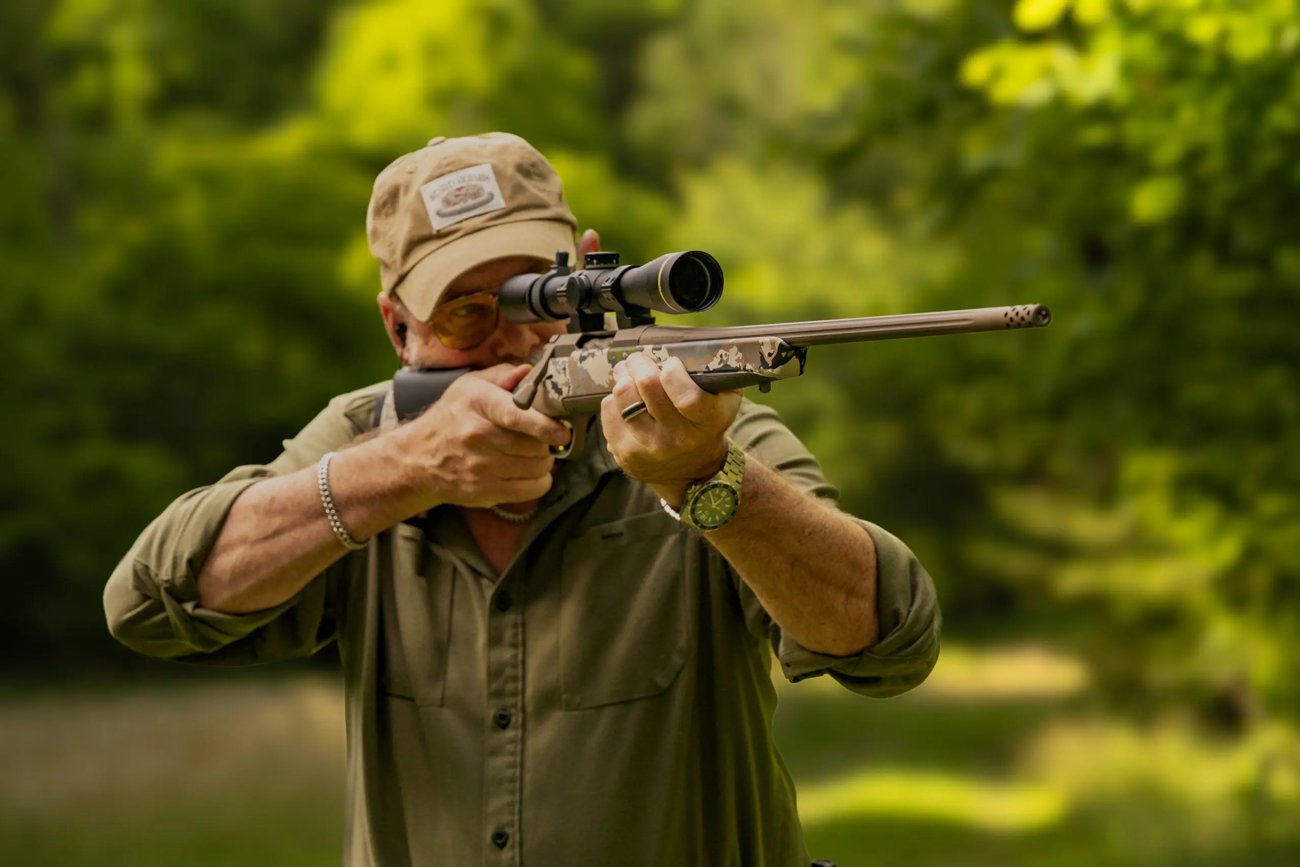 A shooter test fires the new Browning X Bolt 2 Speed OVIX MB at a summer shooting range.