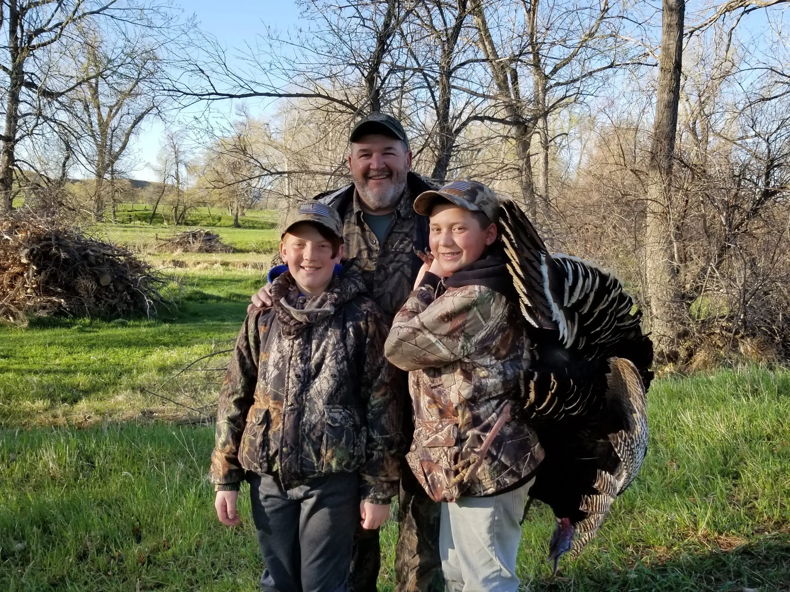 Turkey expert Dave Ciani shows off a tom turkey with his grandsons.