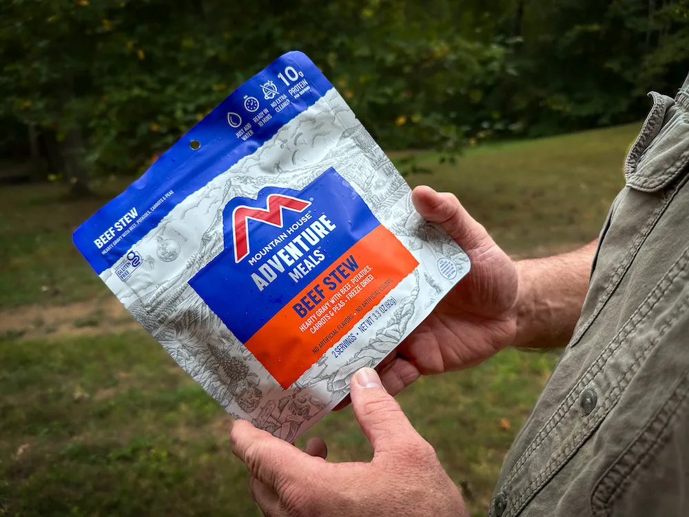 Tester holding Mountain House Adventure Meals Beef Stew pack