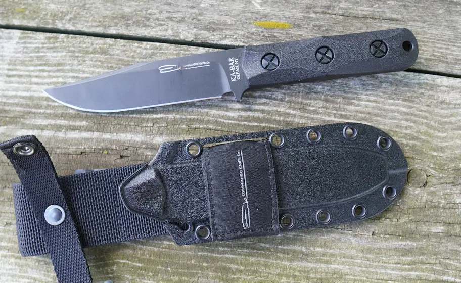 Ka-Bar Ek Commando knife and sheath on wood table