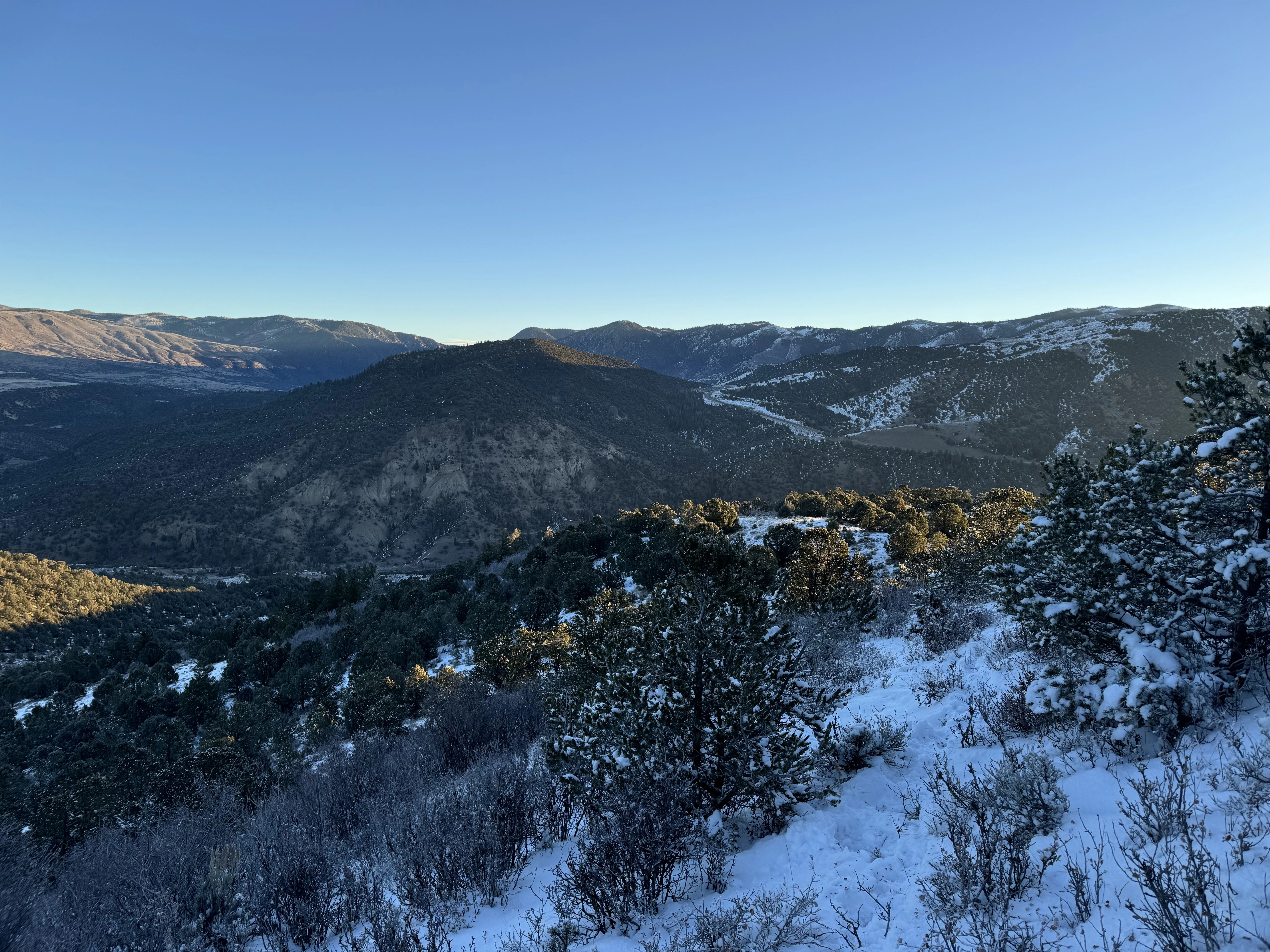 The top of a snowy ridge overlooking the rocky mountains