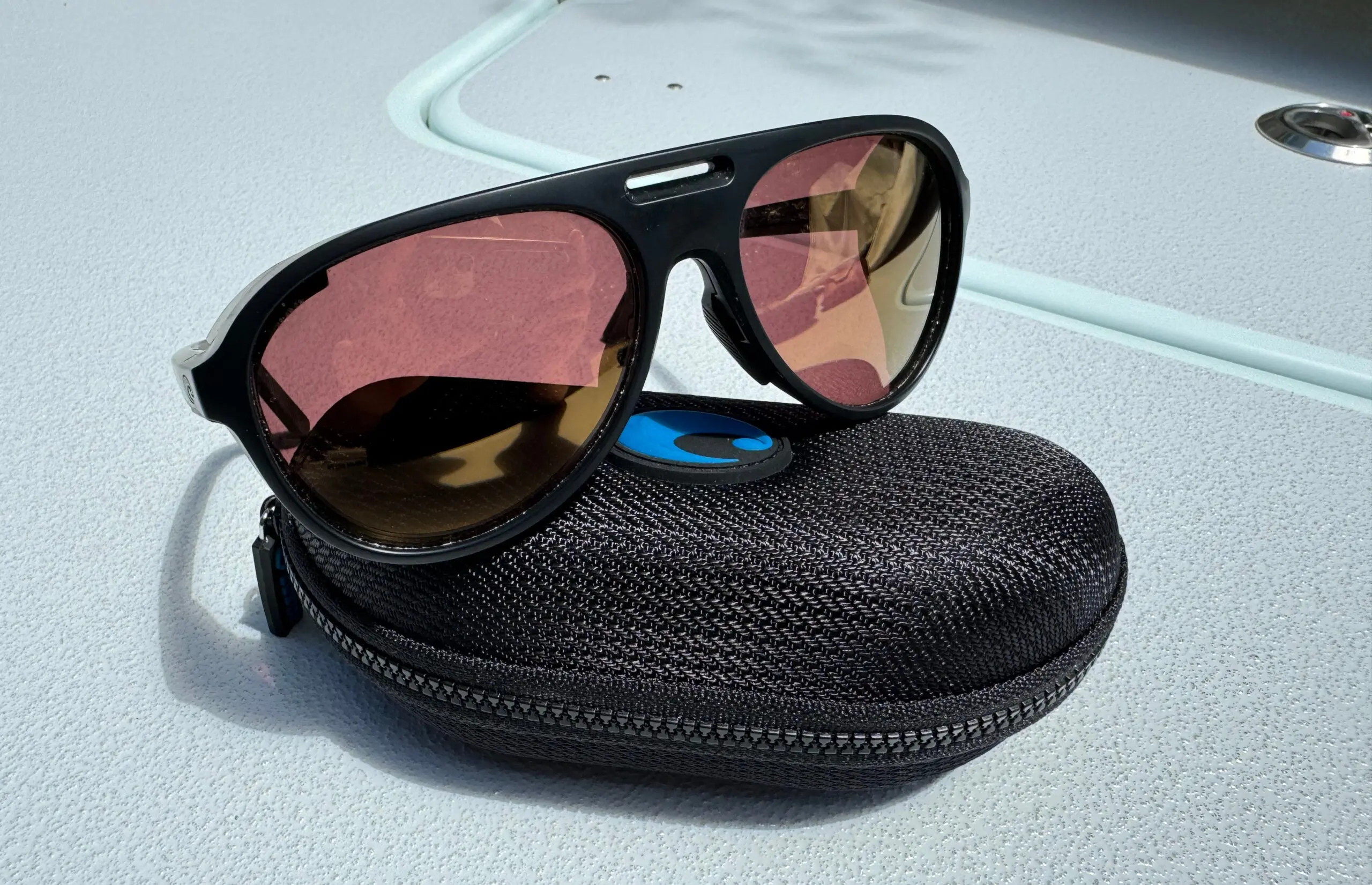 Costa Grand Catalina fishing sunglasses sitting on boat