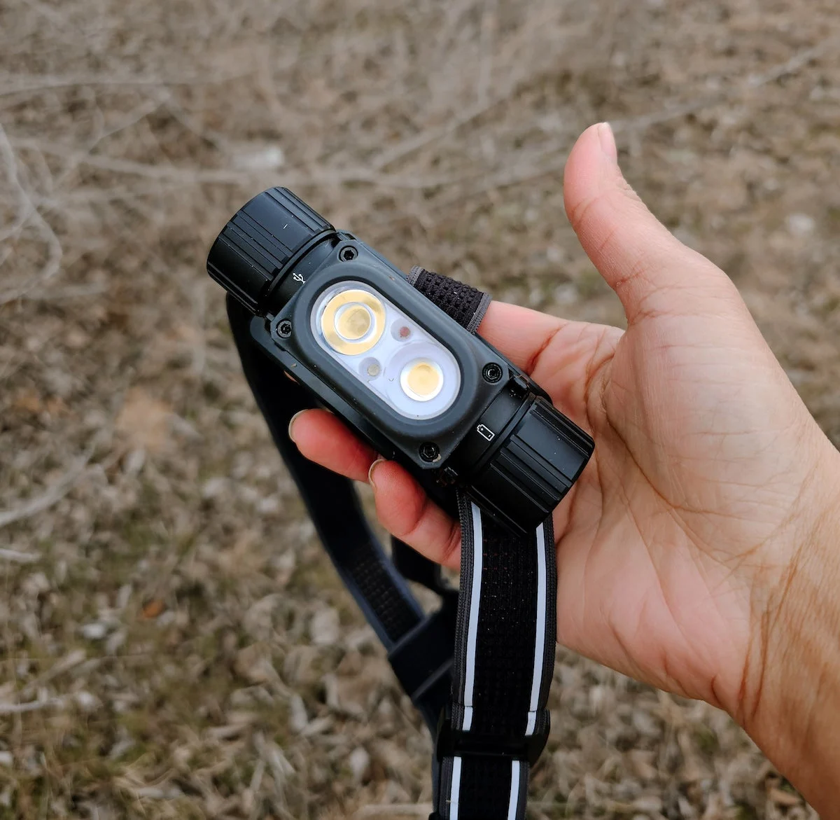 Woman holding Coast WPH34R Headlamp