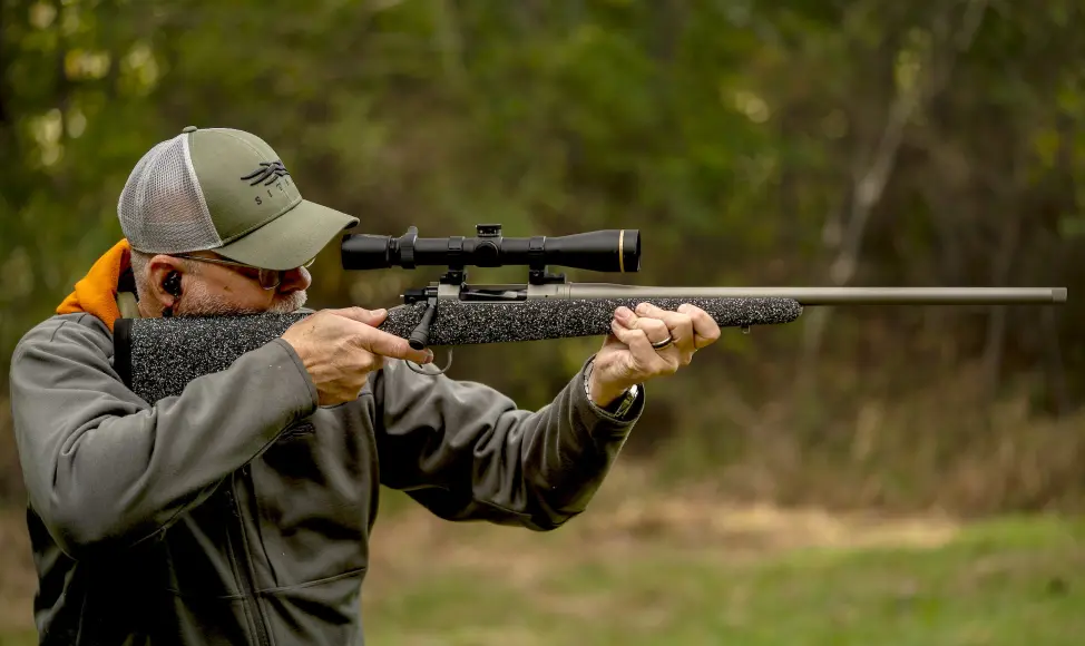 Man shooting a nosler model 21.