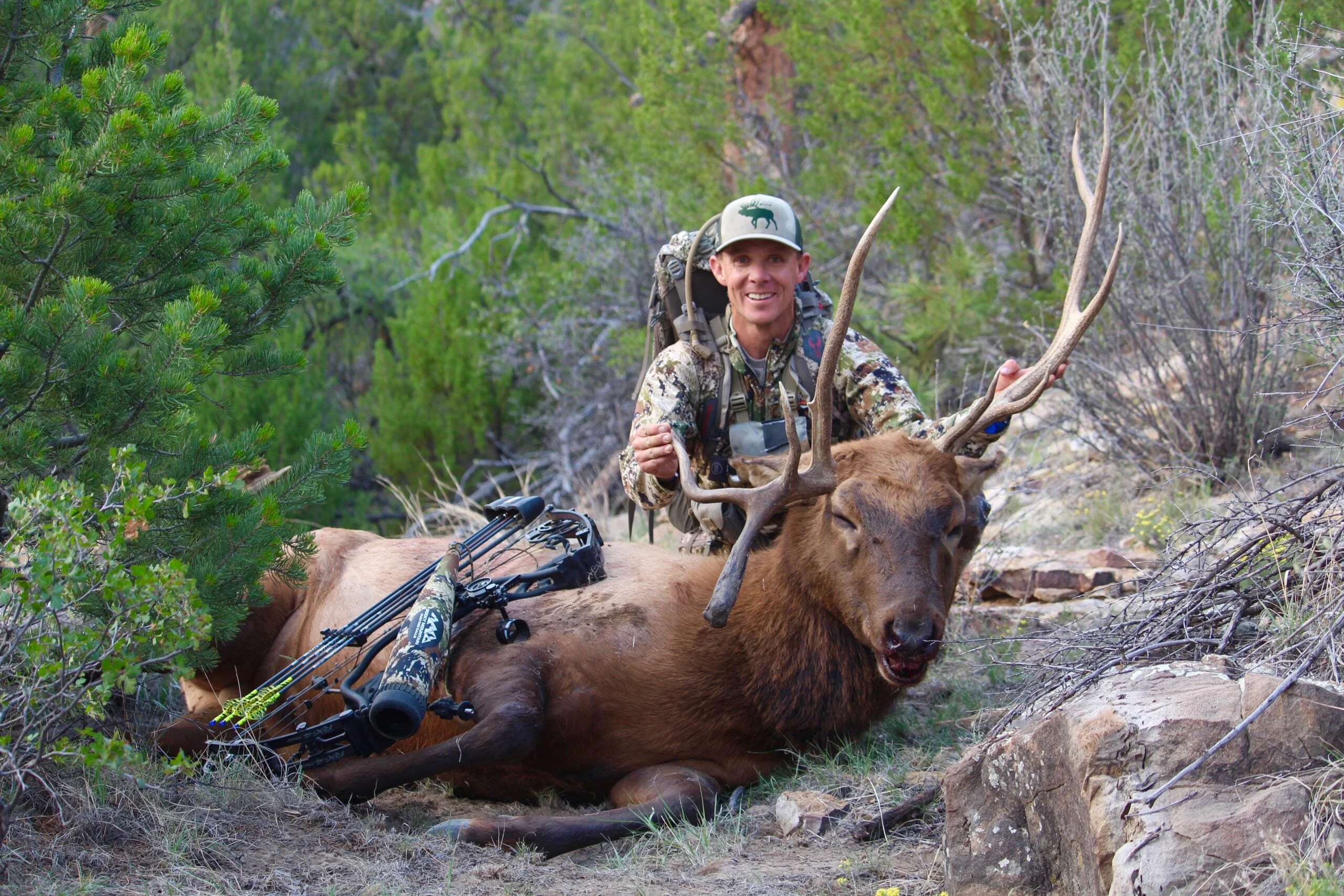 Bow hunter poses with elk