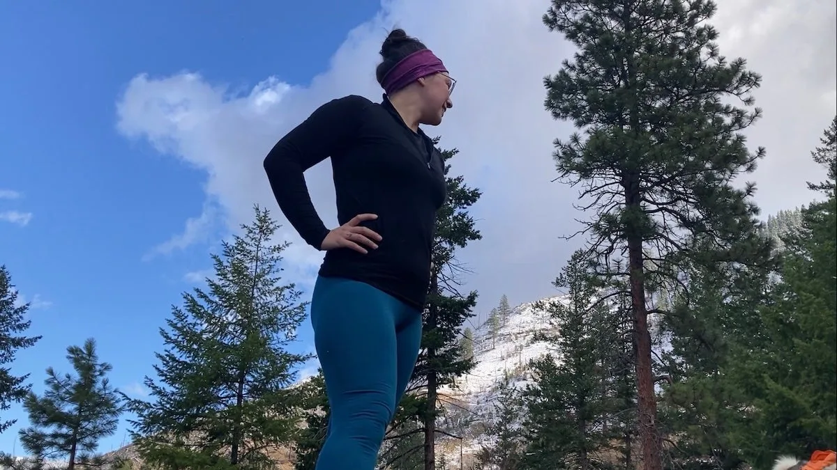 Female hiker wearing Ibex Woolies base layer bottoms