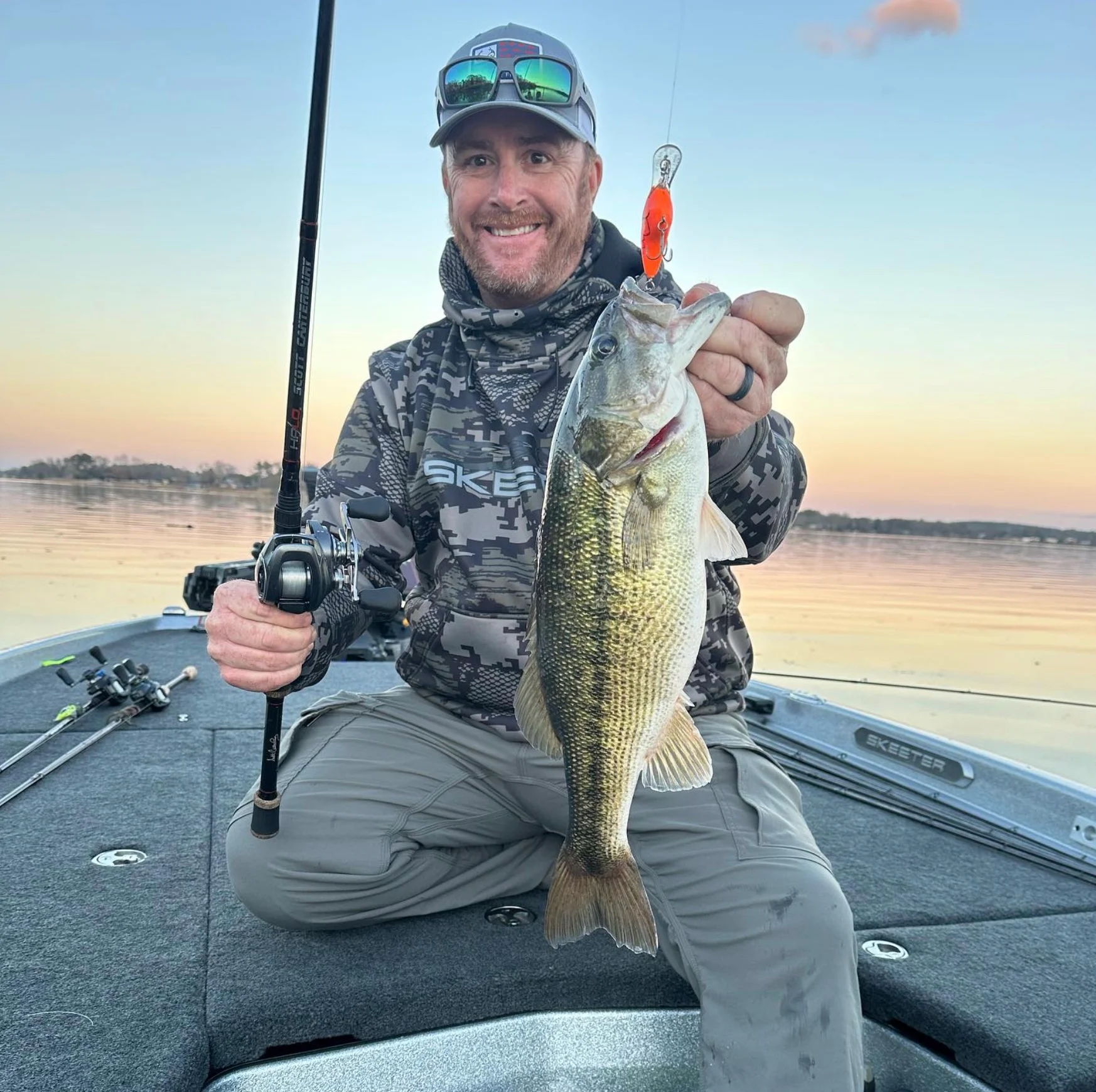 Angler holding up largemouth bass