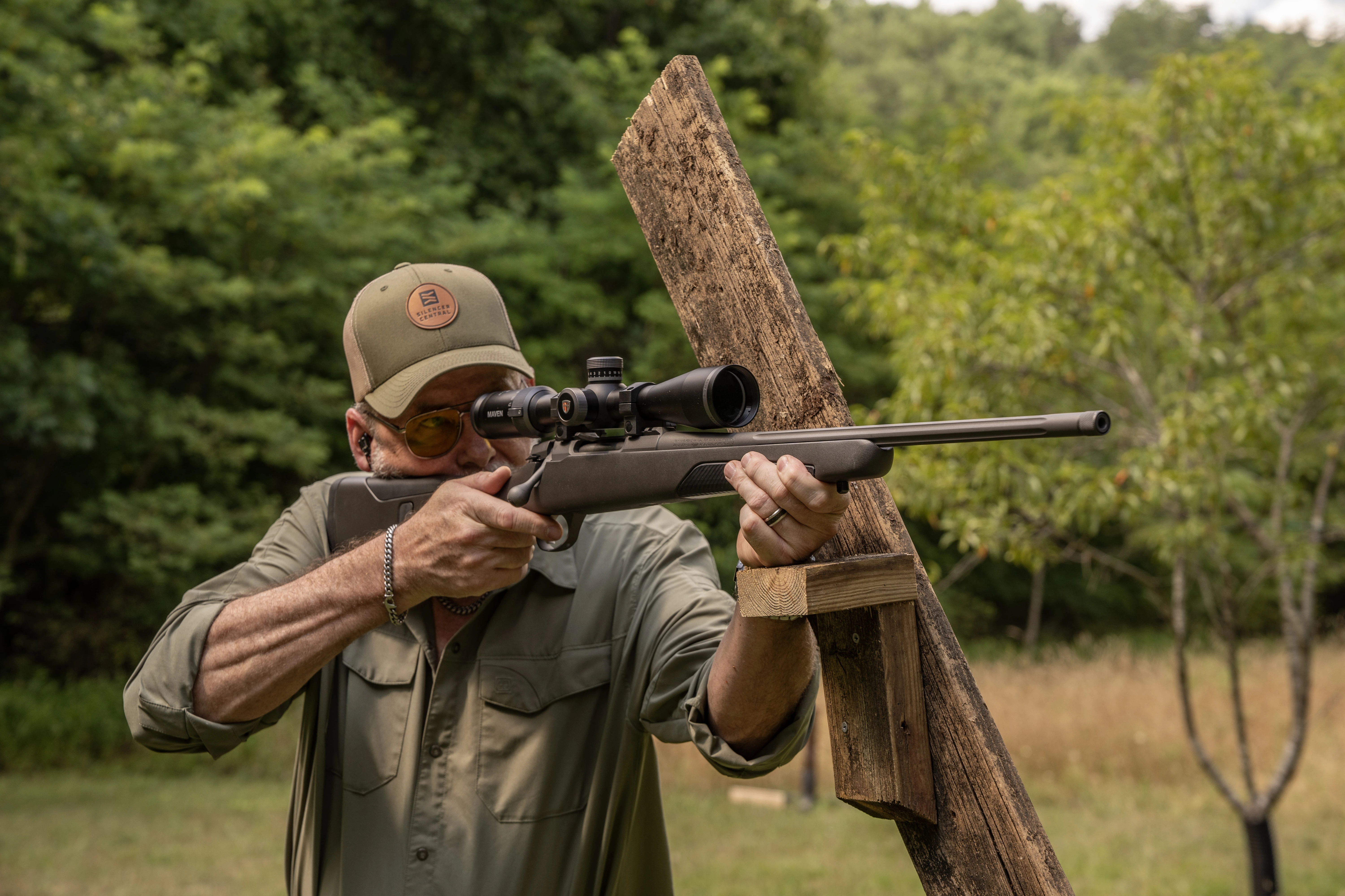 A shooter fires the Sako 90S Adventure bolt-action rifle from a barricade. 