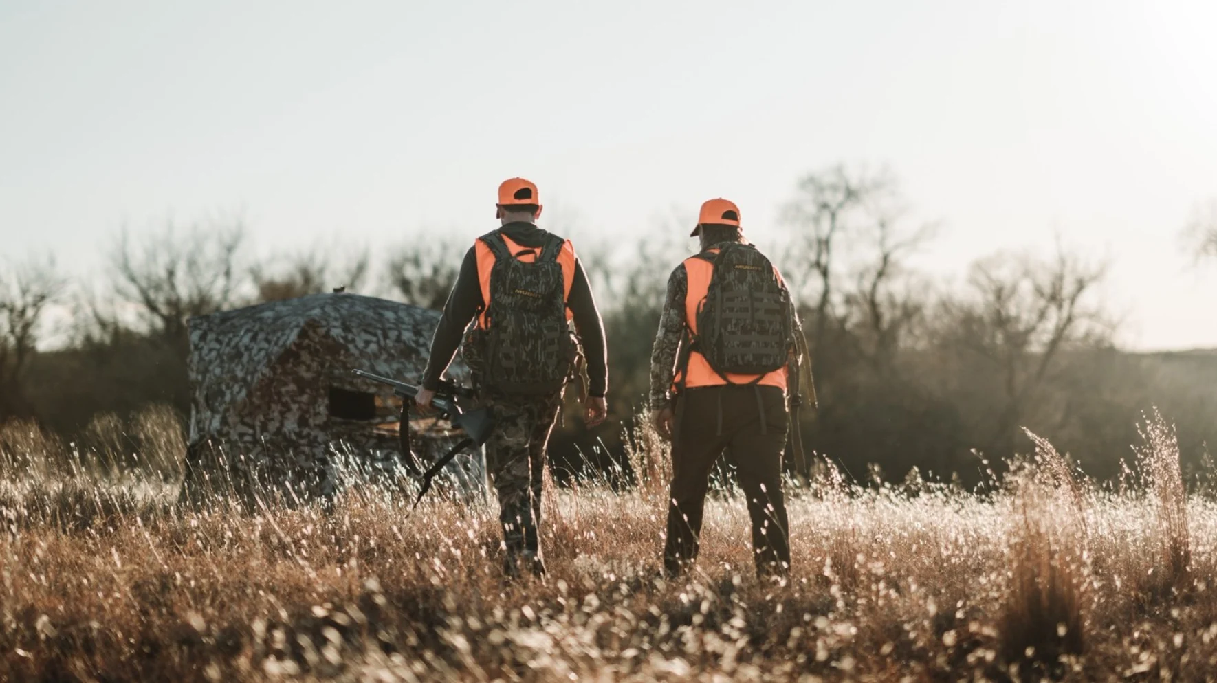 Hunting couple walking to Muddy blind