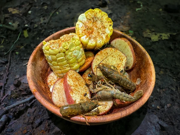 crawfish, corn, and potatoes in a bowl