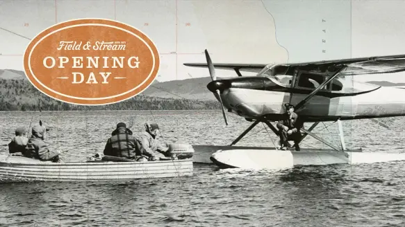 A float plane resting on water next to a canoe