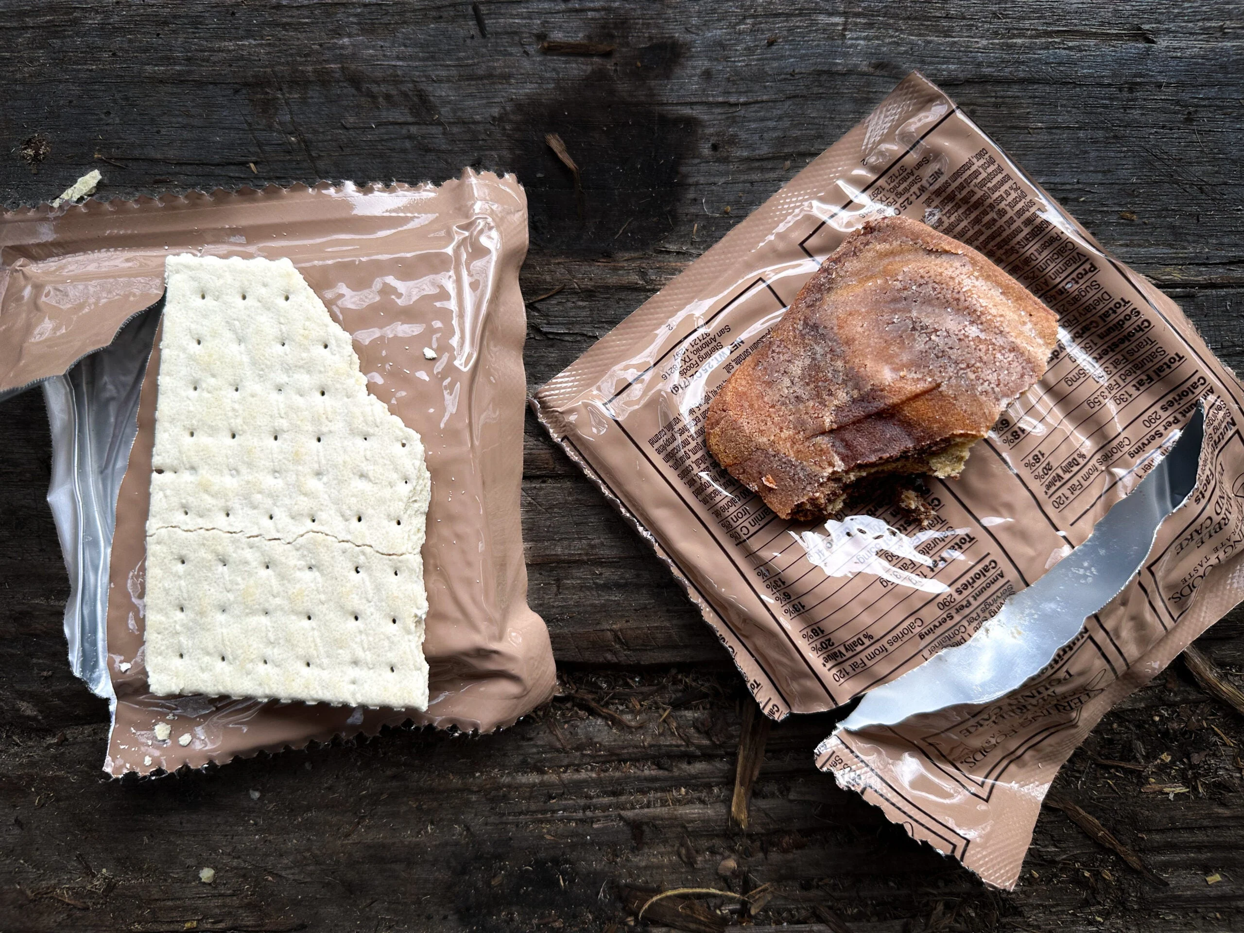 A cracker and entree from an MRE package opened and ready to eat