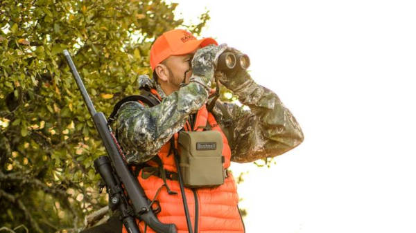 Hunter looking through Bushnell Binoculars