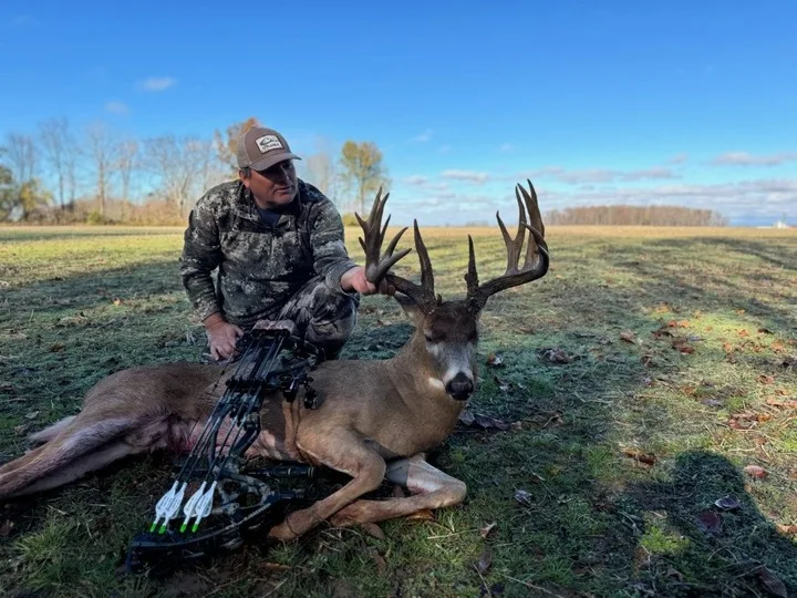 A bowhunter poses with a trophy whitetail taken in Indiana. 