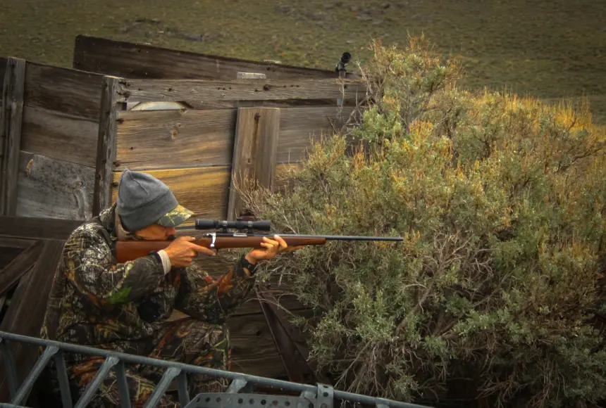 Hunter shooting .22 LR rifle