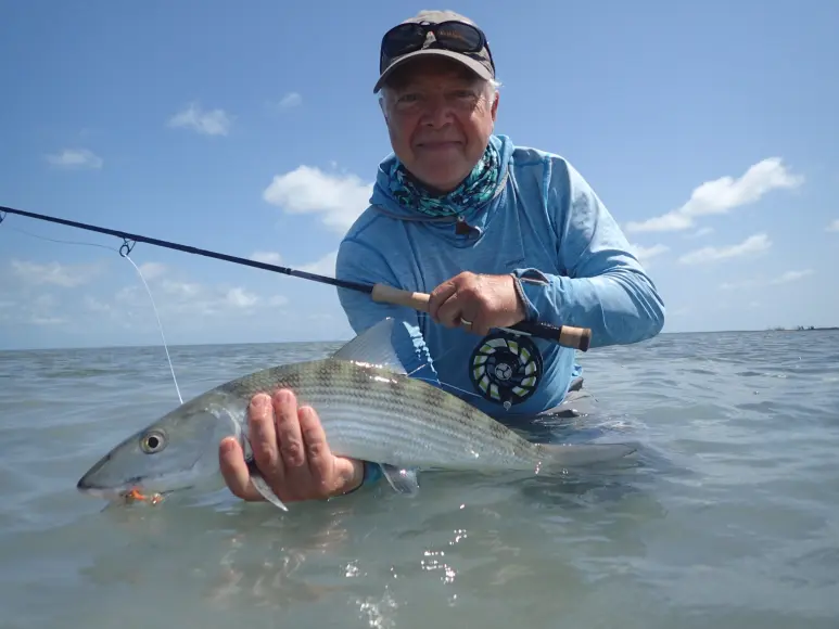 Saltwater fly fisherman catches a bonefish with the Orvis Helios blackout rod