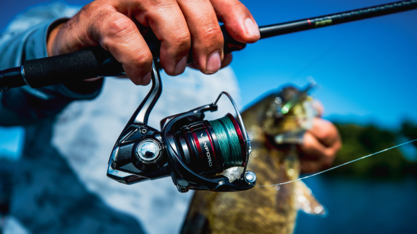 Angler holding up Shimano Vanford spinning reel