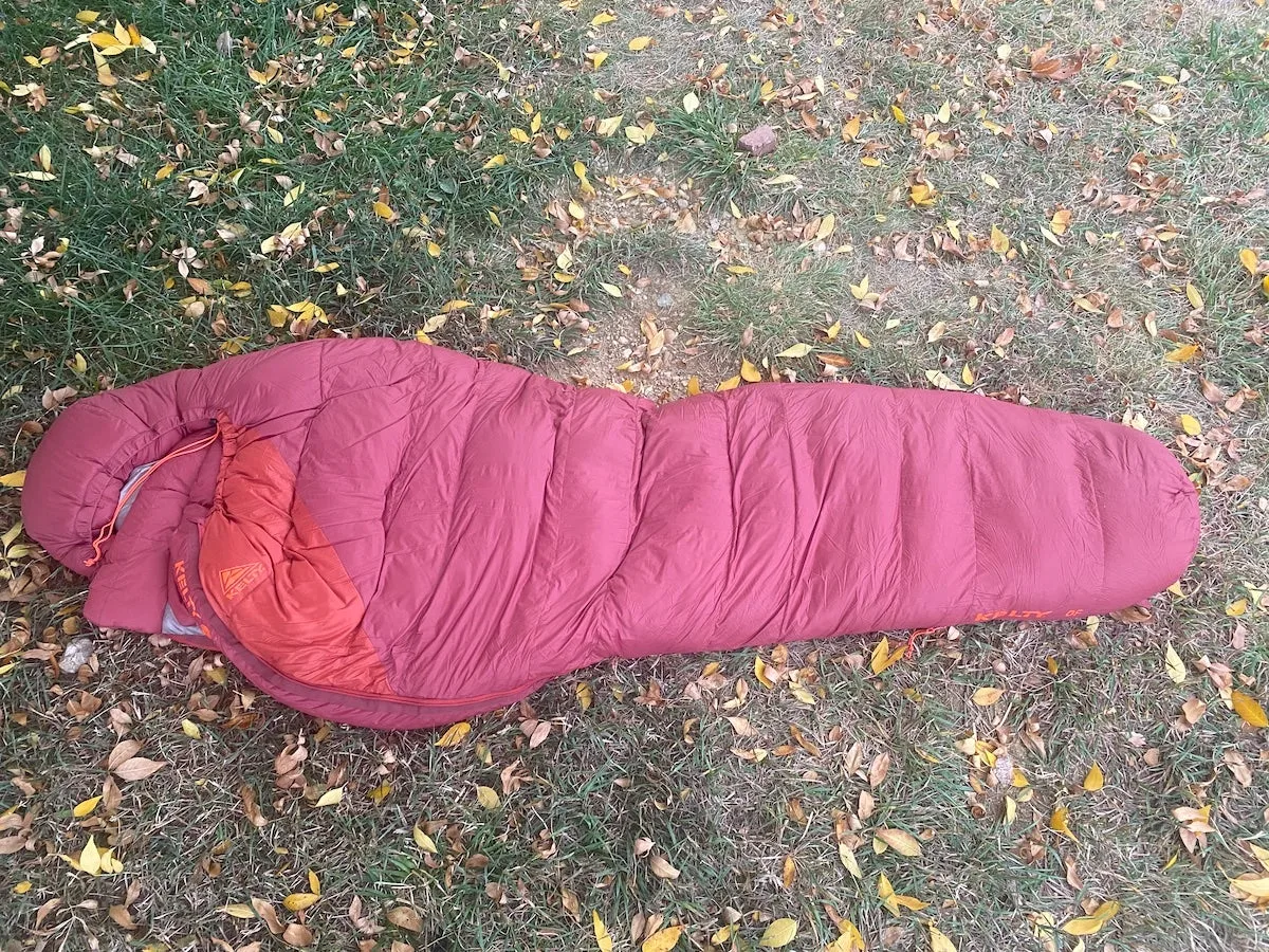 Kelty Cosmic Down 0 Sleeping Bag laid out on grass