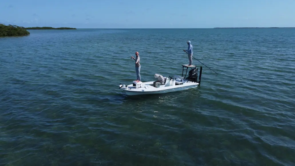 angler casting fly rod on flats boat