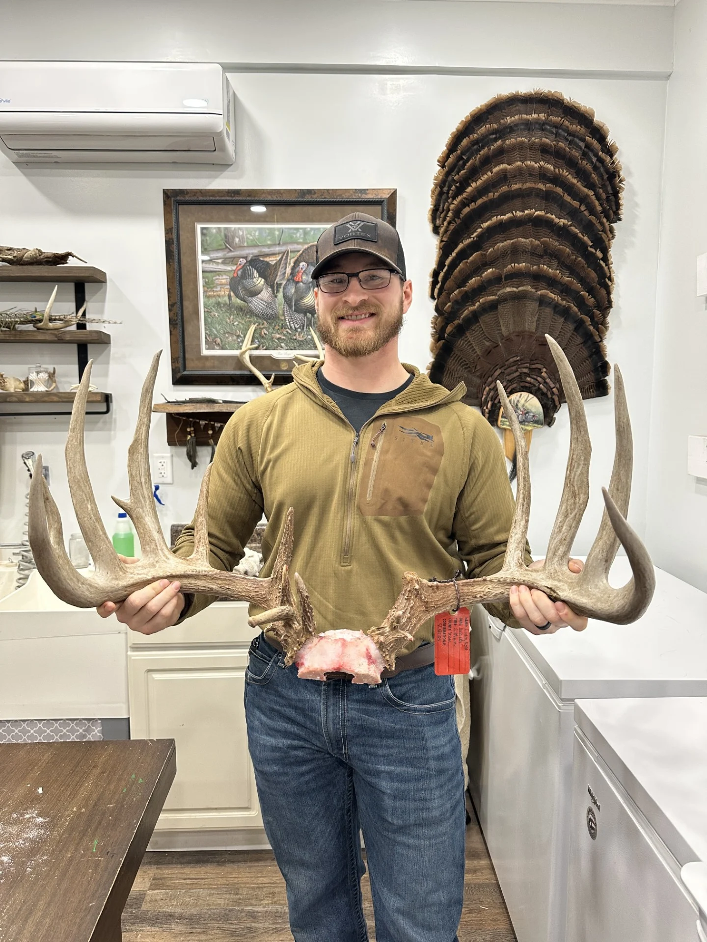 A hunter poses with a trophy whitetail rack. 