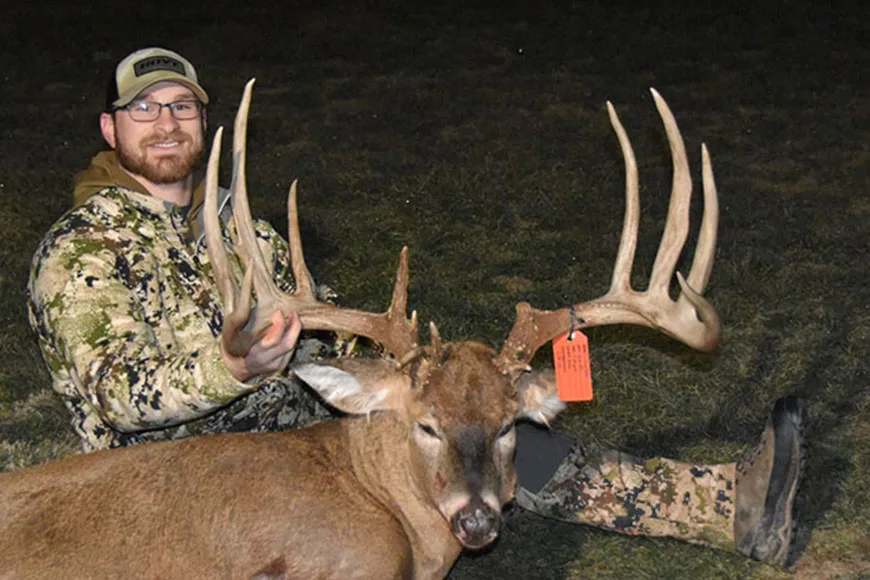 A hunter poses with a giant Ohio whitetail.