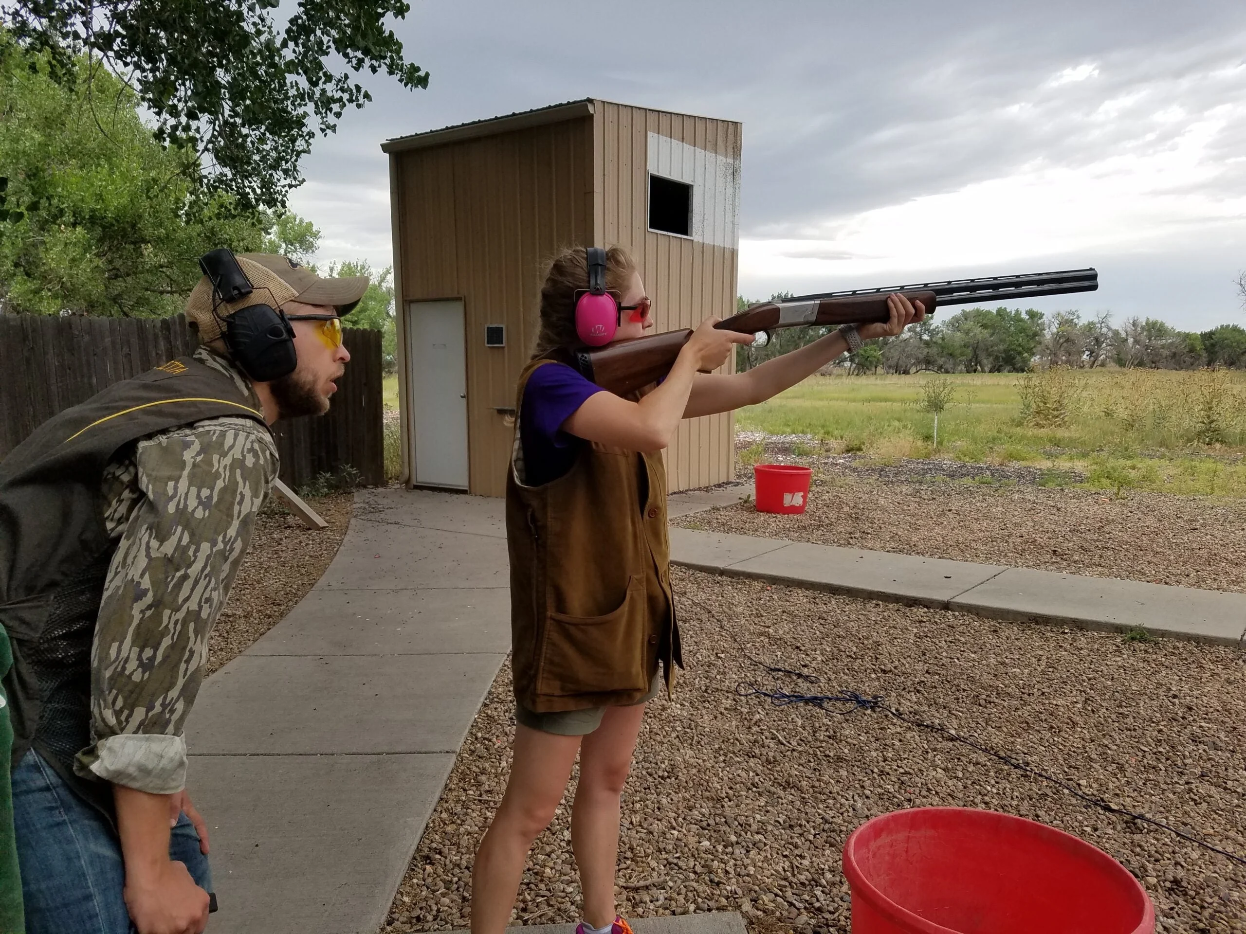 Two shooters shooting skeet.