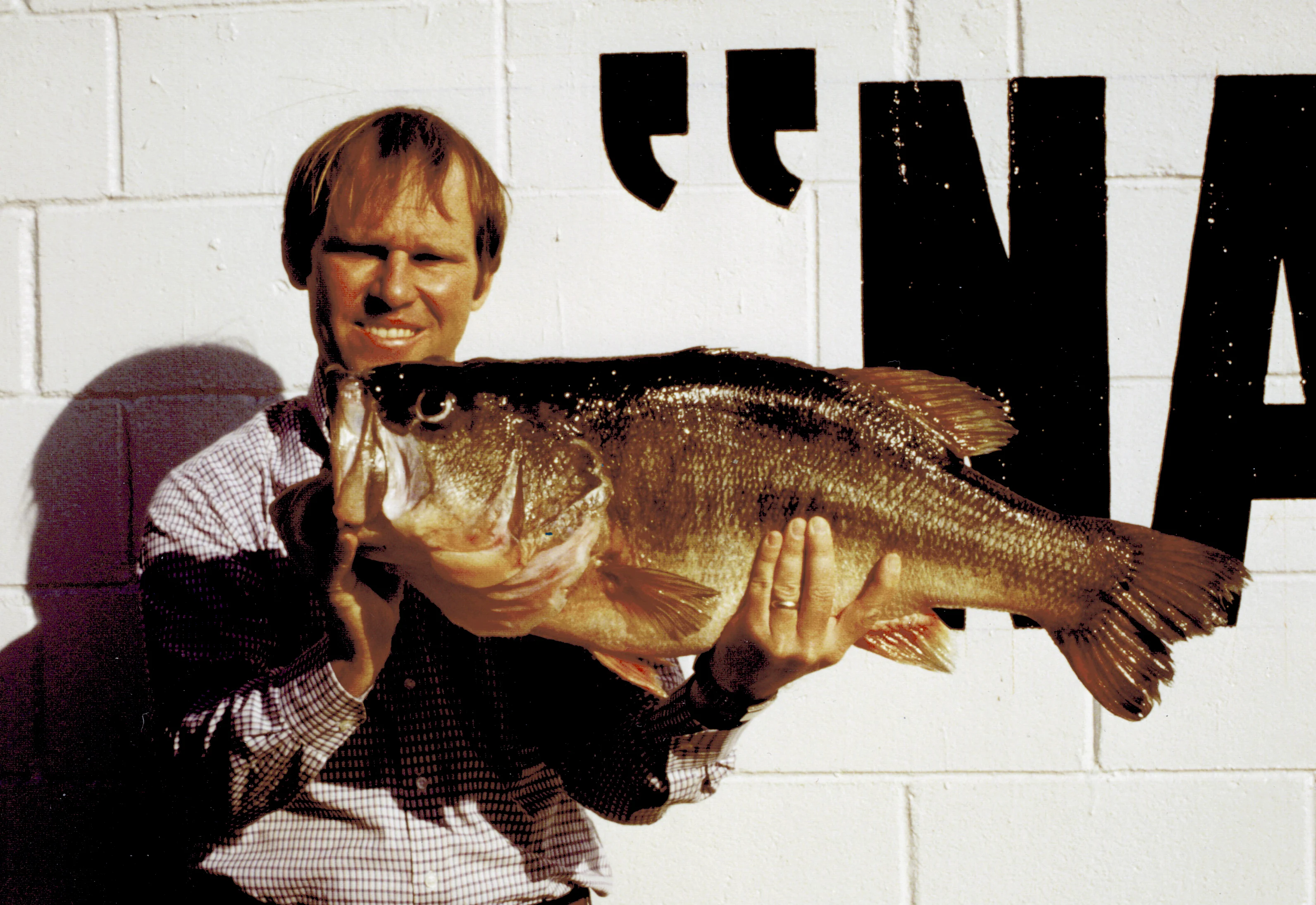 An angler poses with the Alabama record for largemouth bass. 