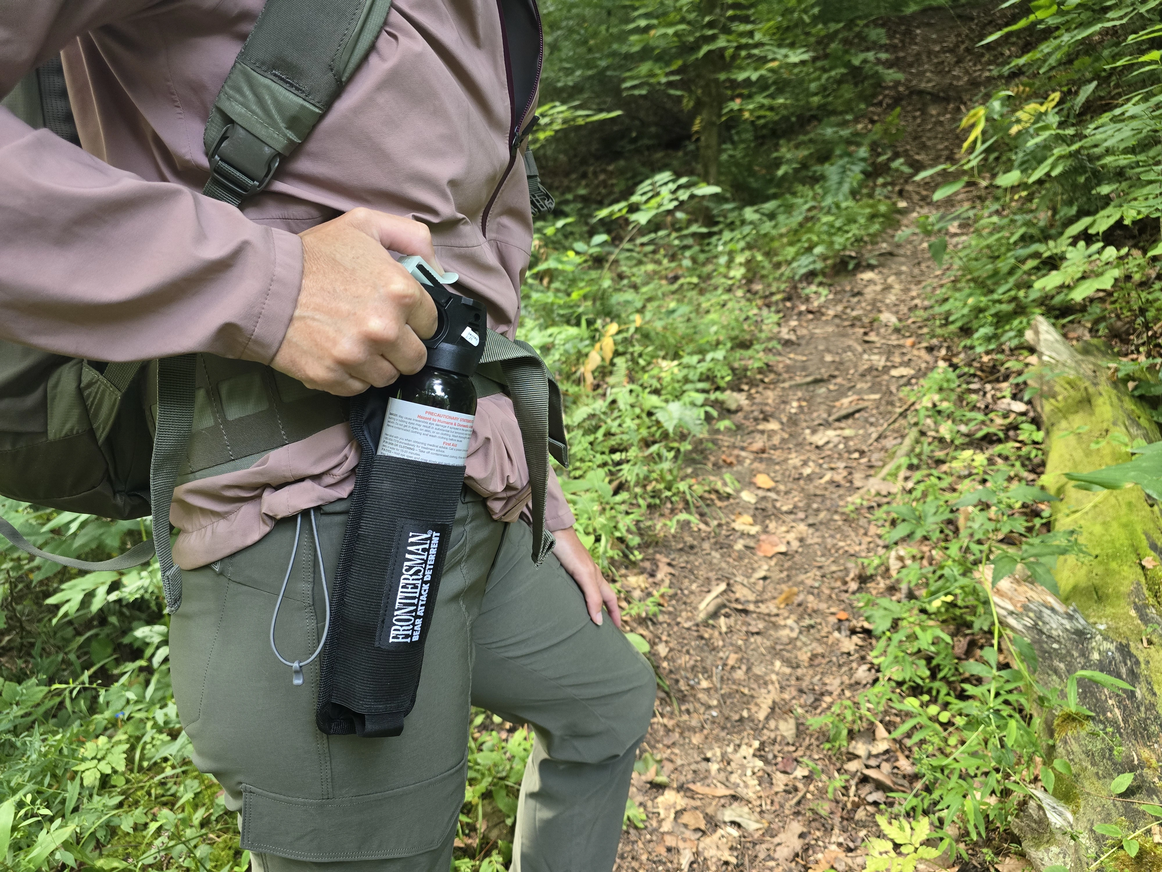 Woman holding bear spray in holster