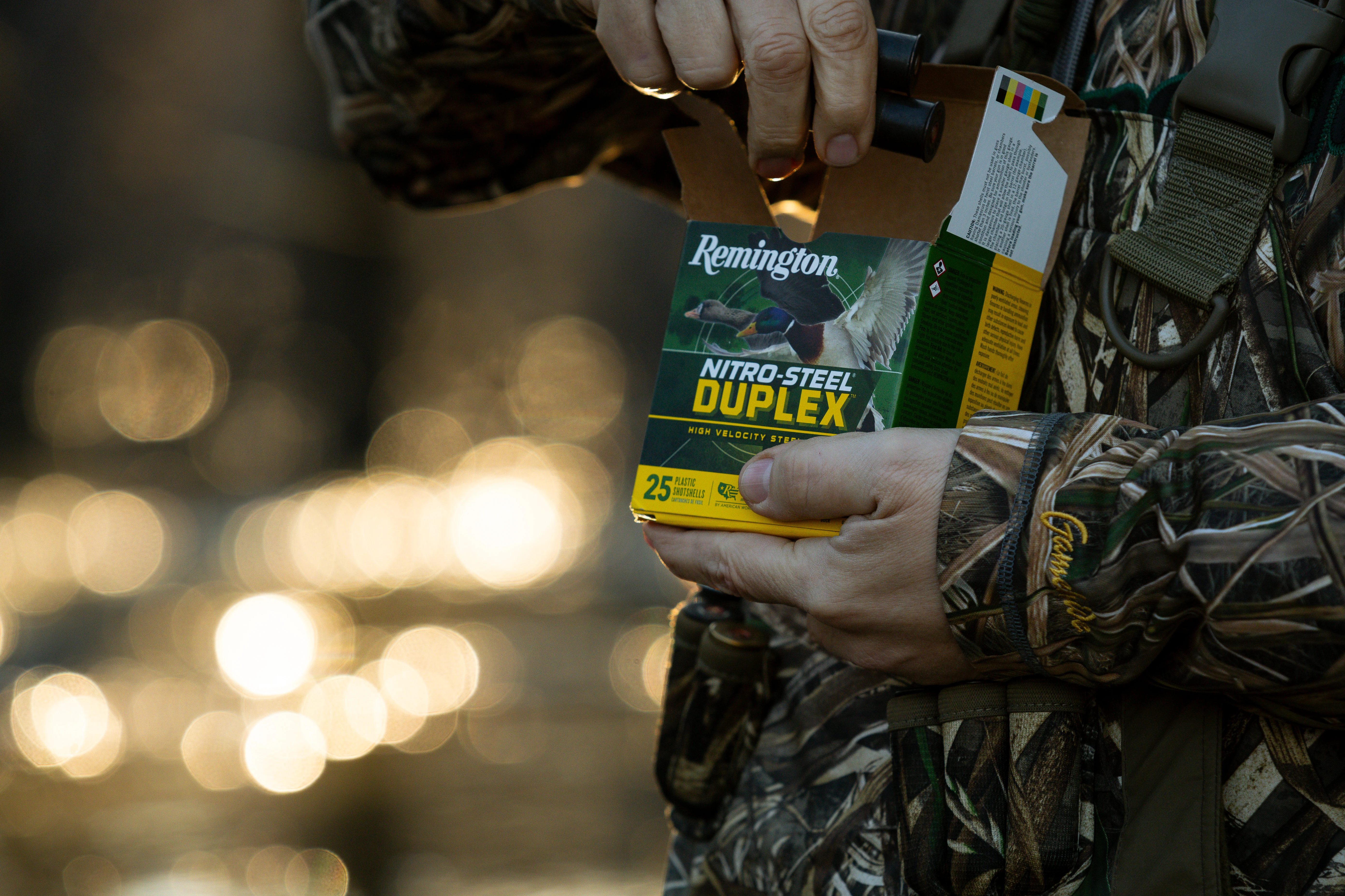 Hunter taking shotgun shells from a box