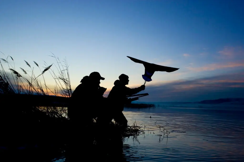 Hunters waiving a goose flag.