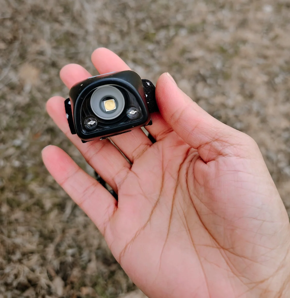 Woman holding Coast FL1R Headlamp