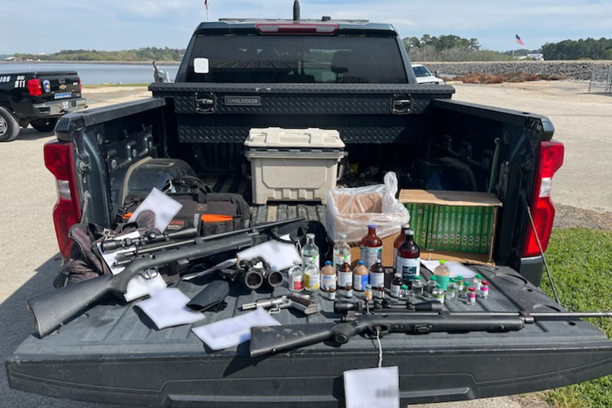 Tranquilizer guns, darts, and drugs seized during a deer smuggling bust in Texas. 