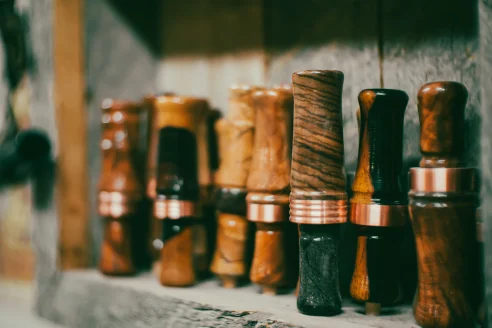duck calls lined up on a shelf