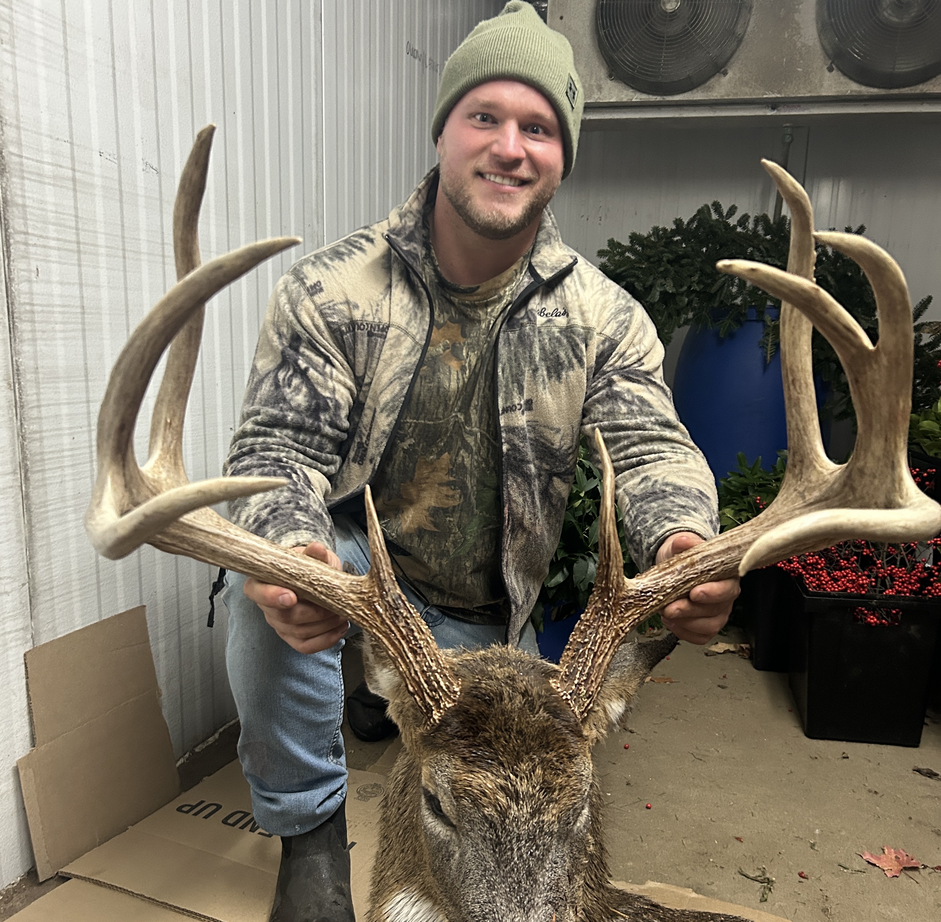 A hunter poses with a trophy whitetail buck