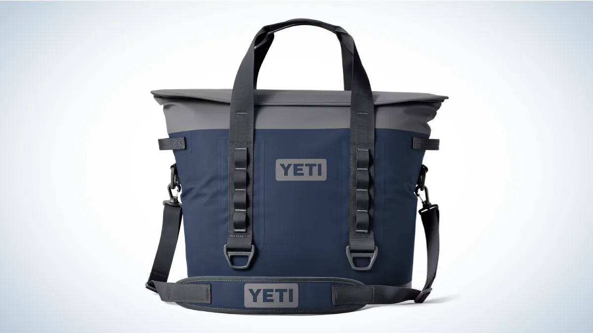 The blue and gray Yeti Hopper M30 Soft Cooler on a gray and white gradient background.