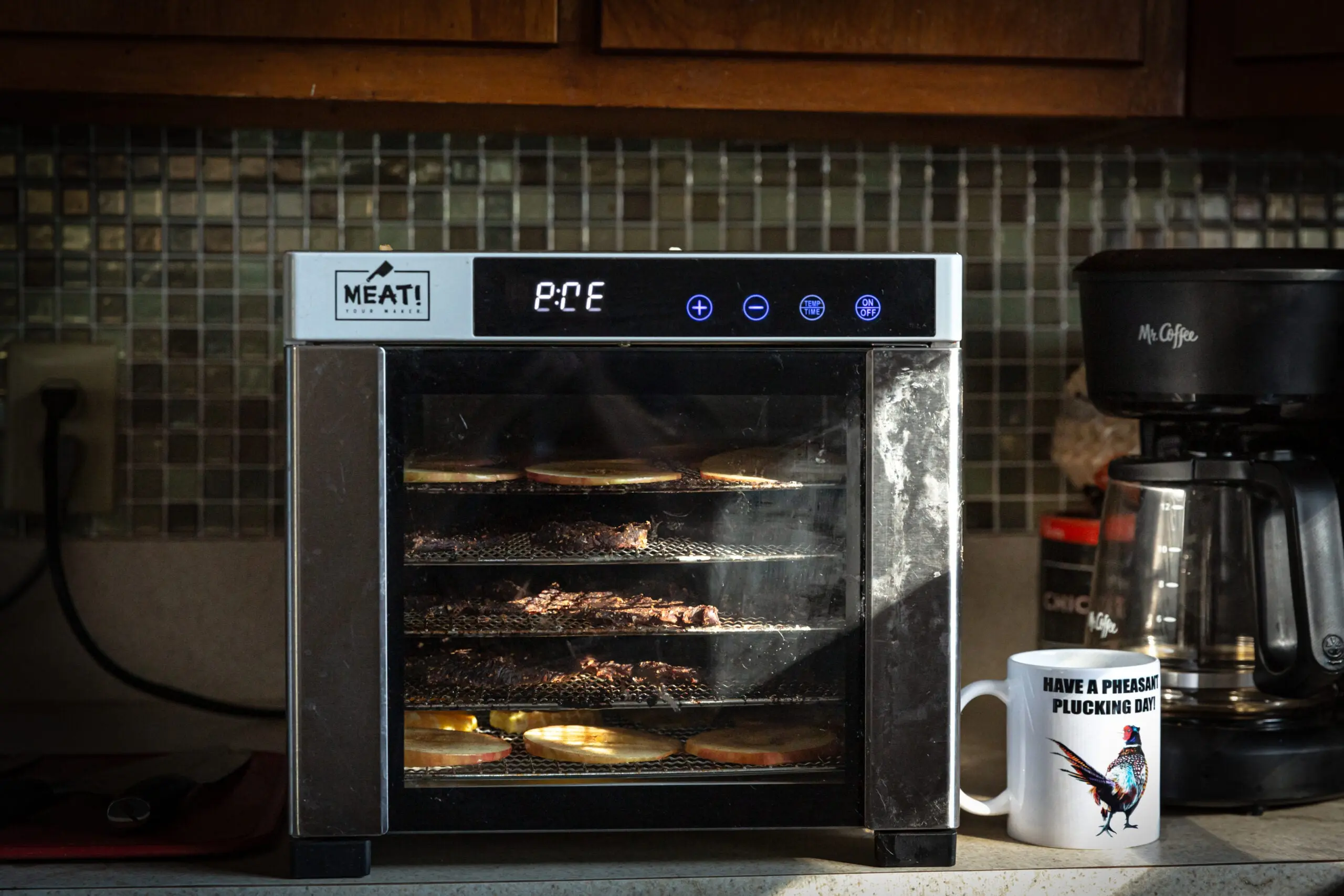 Photo of a dehydrator filled with meats and fruits