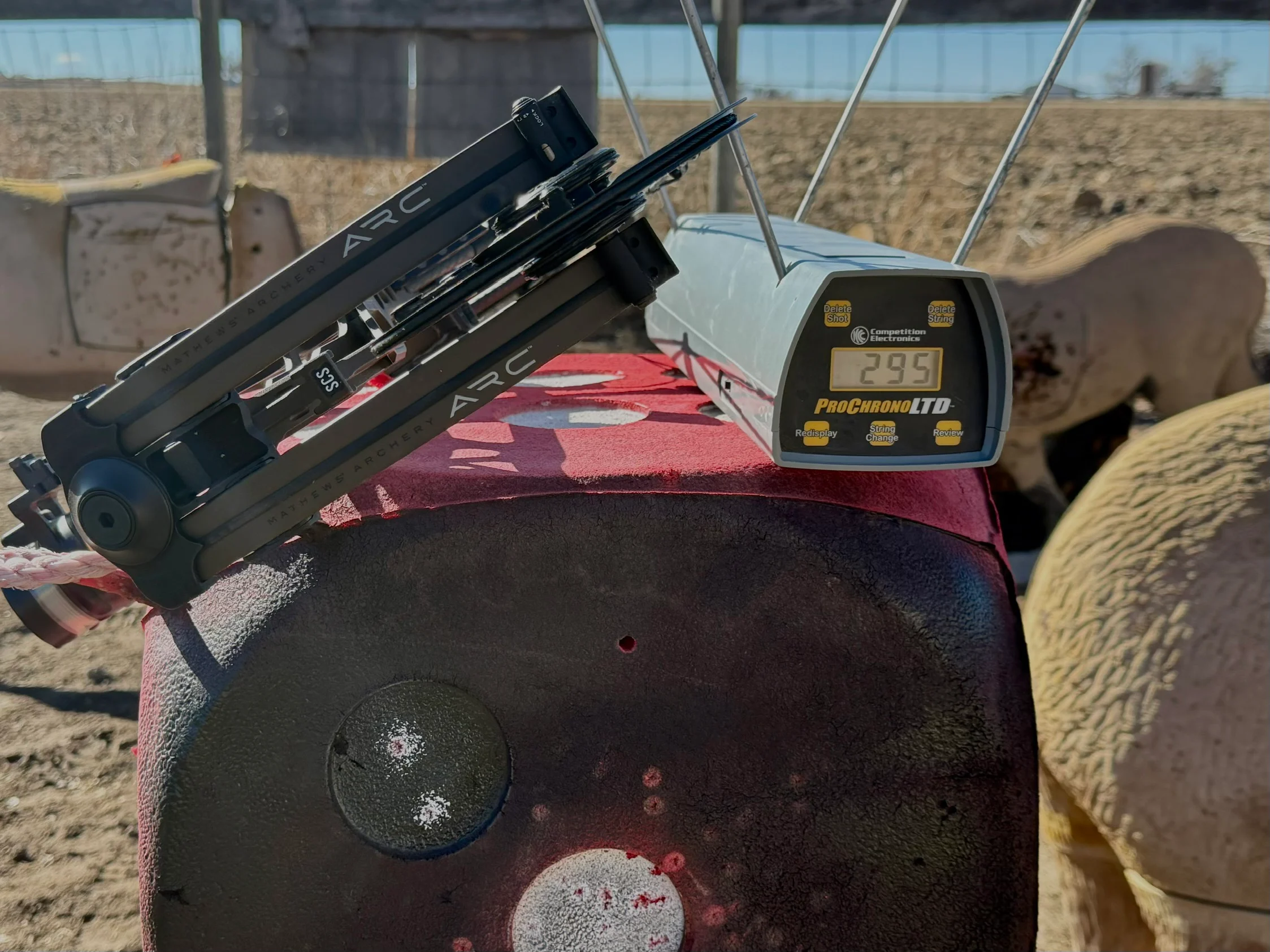 The Mathews ARC 30 compound bow resting on a target with a chronograph reading 295 fps.