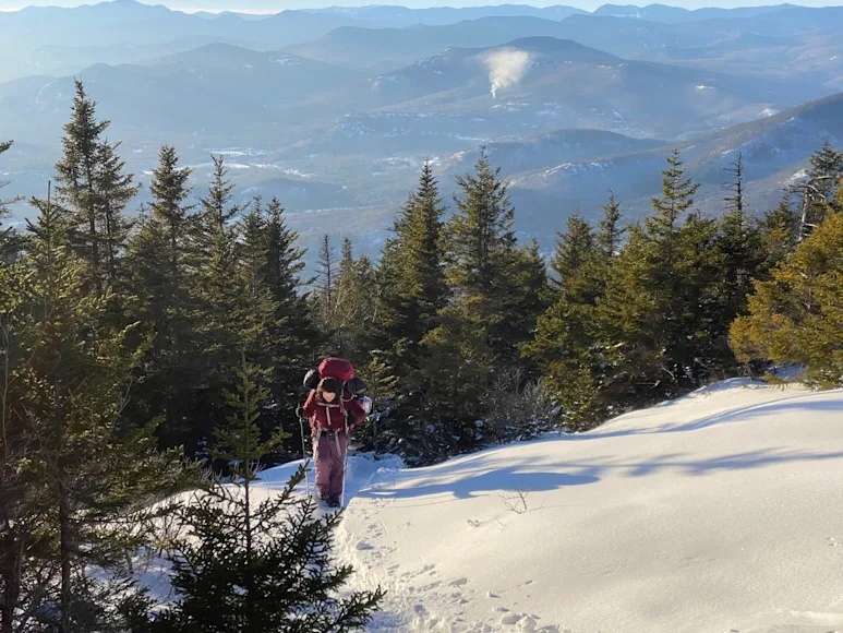 Hiker climbing a snowy mountain, best snowshoes Field & Stream