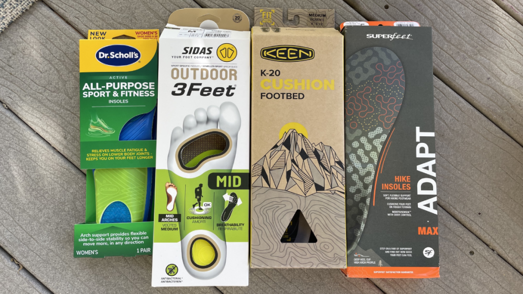 Packs of insoles for hiking lined up: Dr. Scholl's, Sidas, Keen, Superfeet