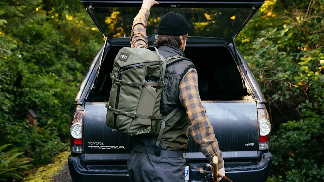 Man wearing Yeti Ranchero Backpack in woods